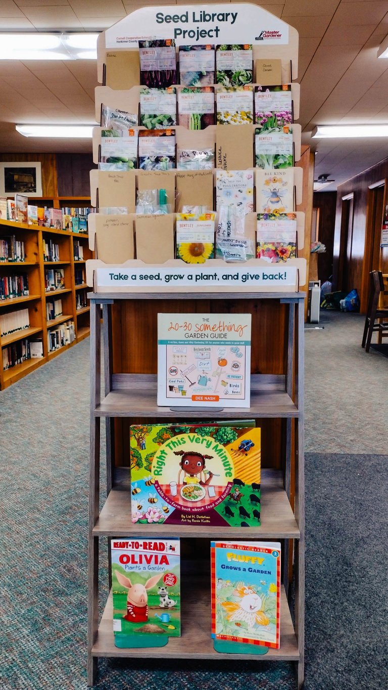 Seed library display with book display beneath it