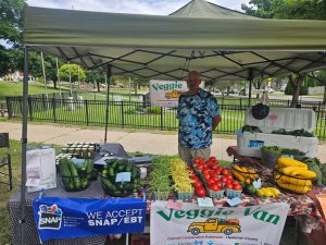 man behind produce table